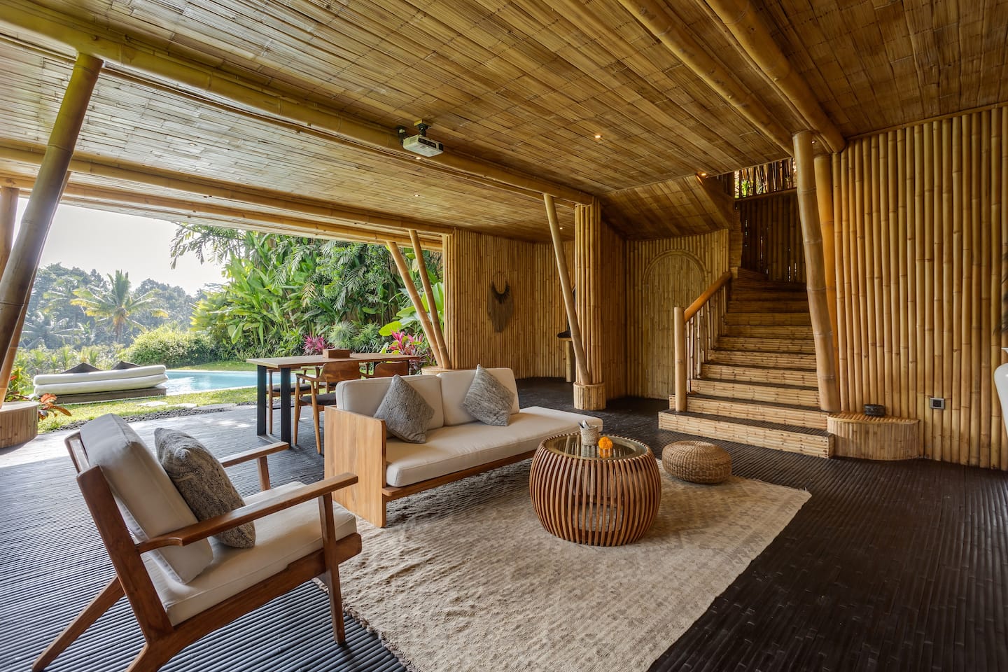 Open bamboo villa with a private pool and tropical gardens at Eco Six Bali