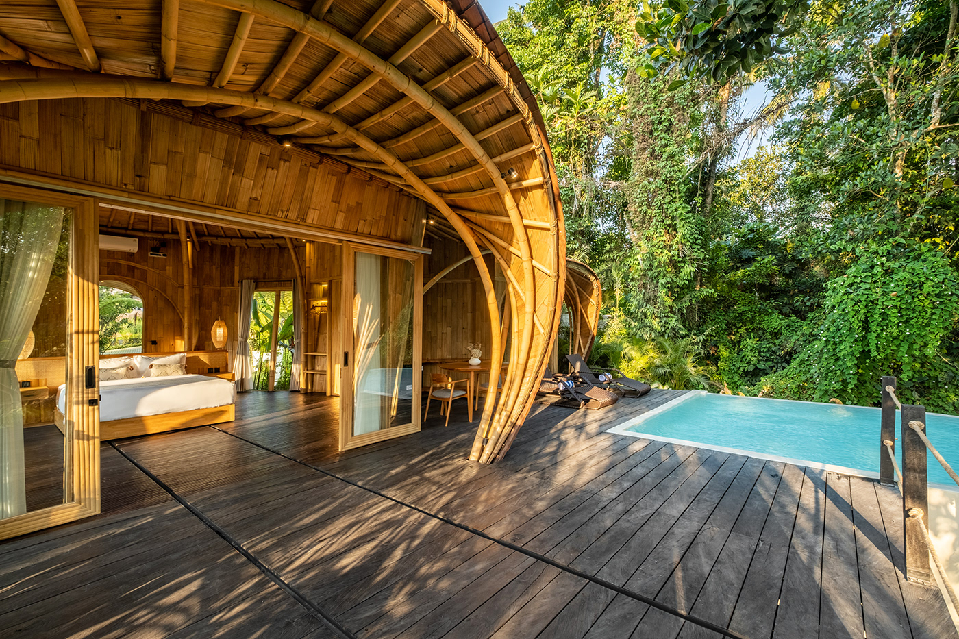 Bamboo architecture opening onto a private pool at Jungleight Bali